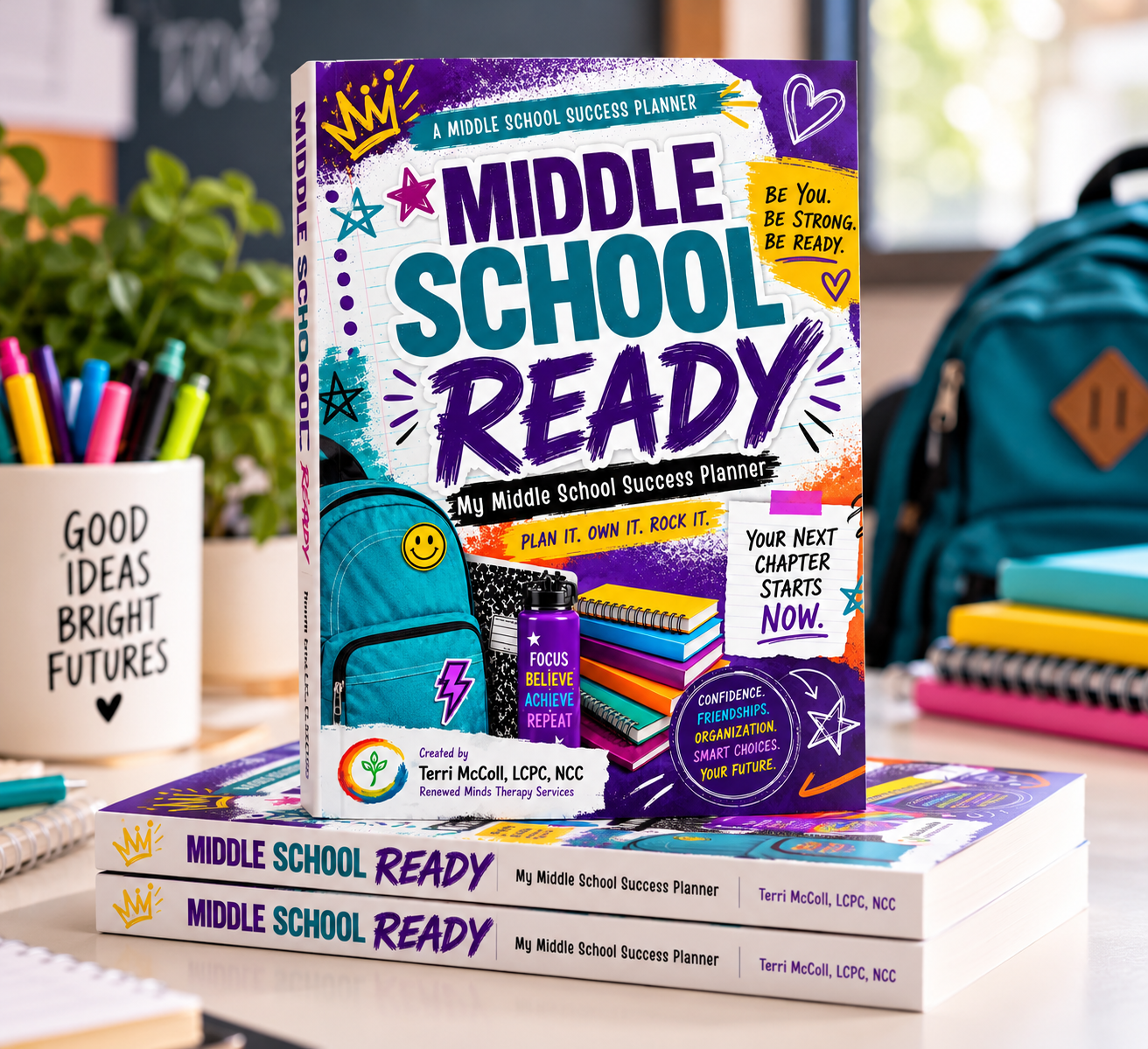 Middle School Ready: My Middle School Success Planner by Terri McColl, LCPC, NCC — the paperback standing on a stack of copies beside a backpack, notebooks and school supplies
